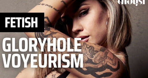 Heavily Tattooed Blonde Alternative Model poses wearing black eyeliner and plump lips