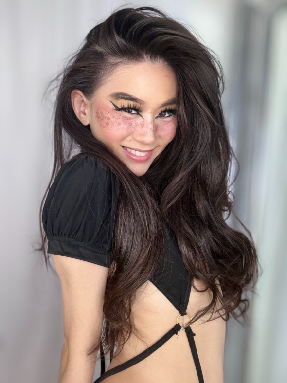 Fun flirty Asian girl with a skimpy little one piece